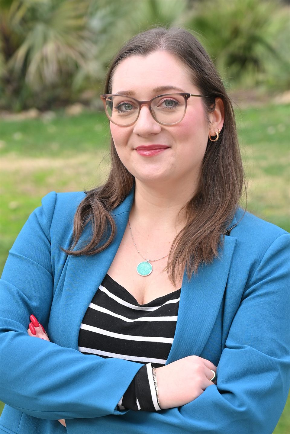 Alexa, founder of Eccola, standing in a park in Rome wearing a blue blazer